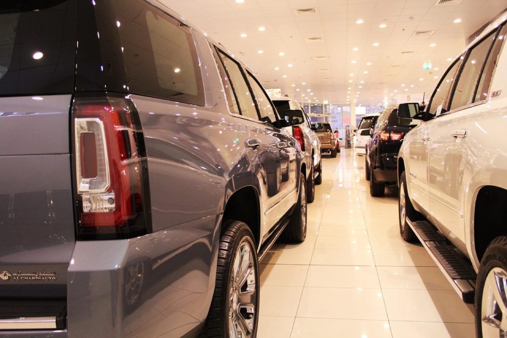 New cars lined up in a dealership showroom.