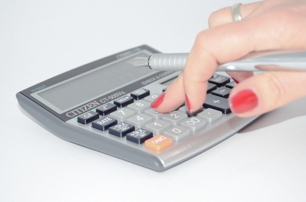 Working through the numbers on a calculator at a desk.
